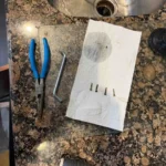 Removing screws that were jamming a disposal