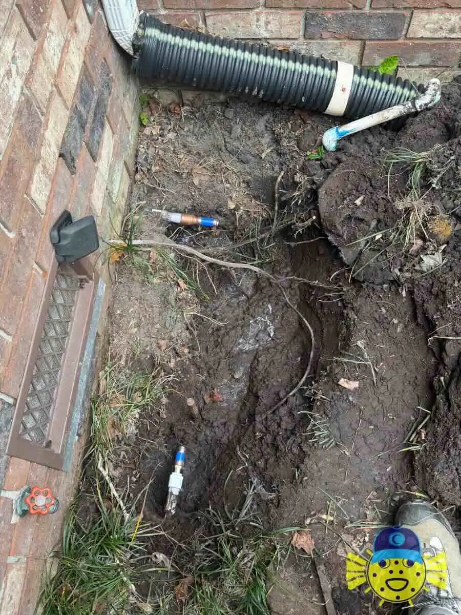 Capped water supply lines underground after removing a DCVA backflow assembly near a brick foundation in North Charleston, SC.