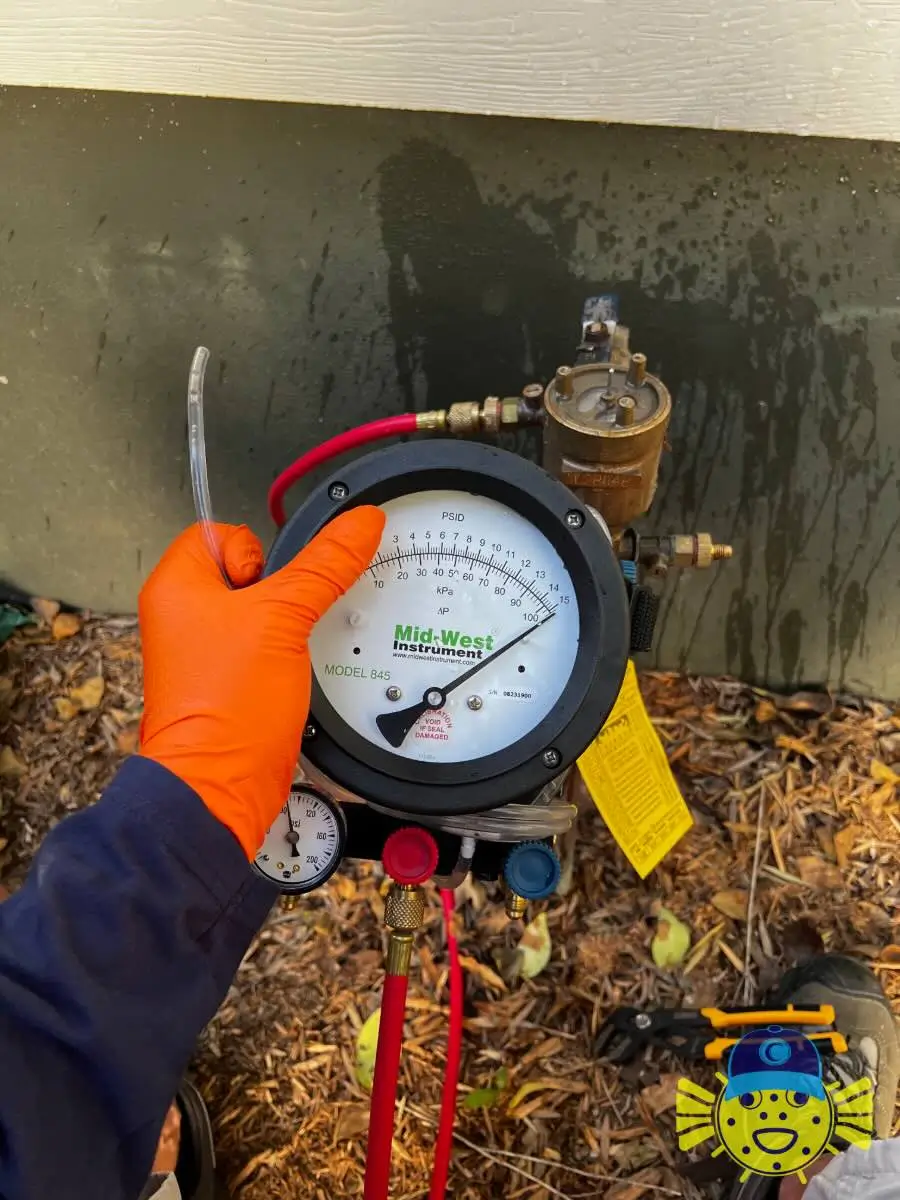 Plumber performing a backflow test using a Mid-West Instrument gauge in Moncks Corner, SC by Swell Guy Plumbing.