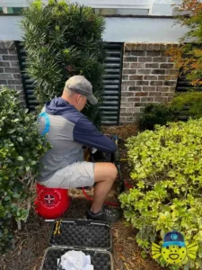 Swell Guy Plumbing technician performing backflow testing on an outdoor assembly in Goose Creek, SC