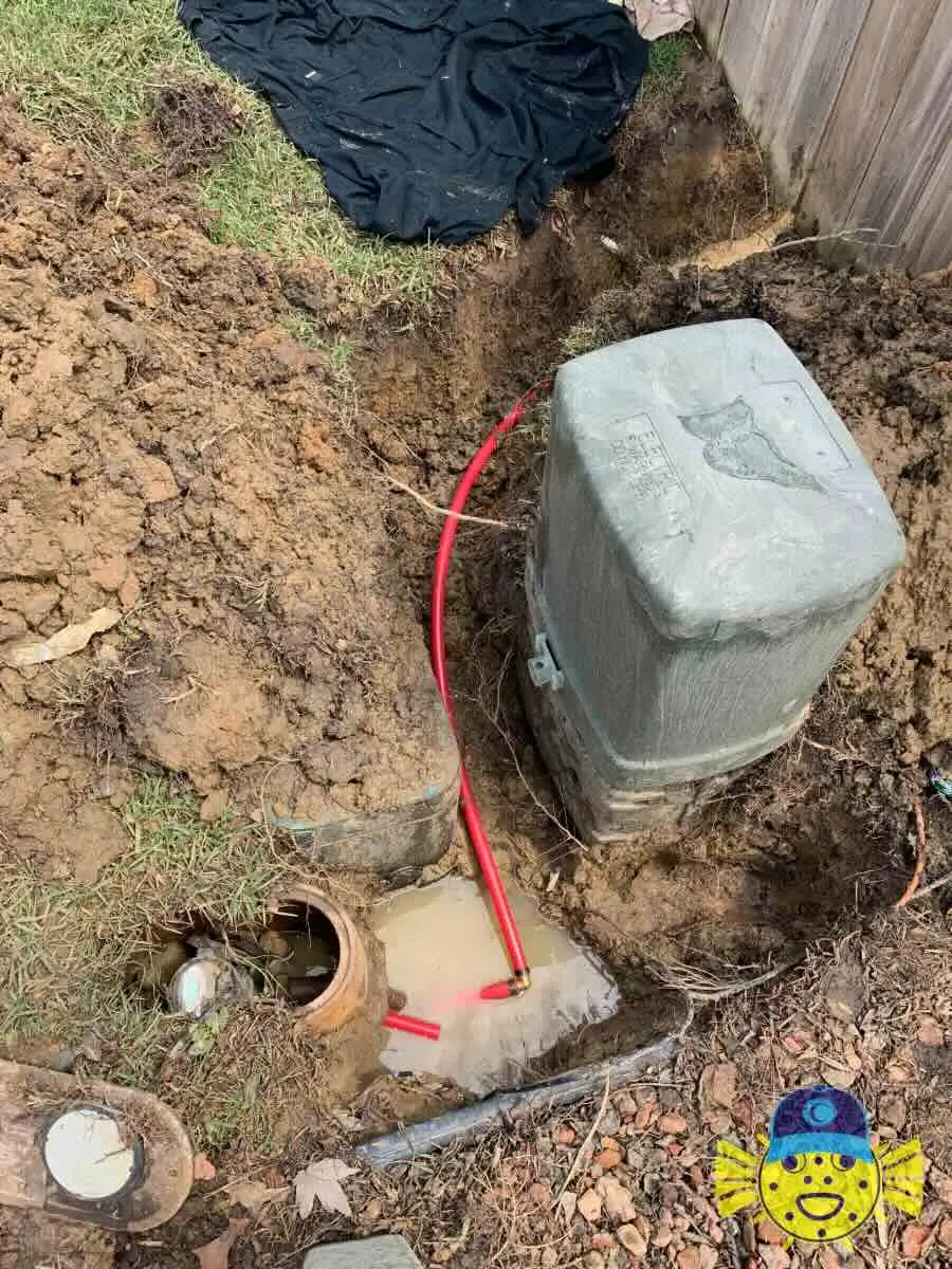 Underground water line repair in Hanahan, SC showing a newly installed red PEX pipe bypass near a utility box by Swell Guy Plumbing.