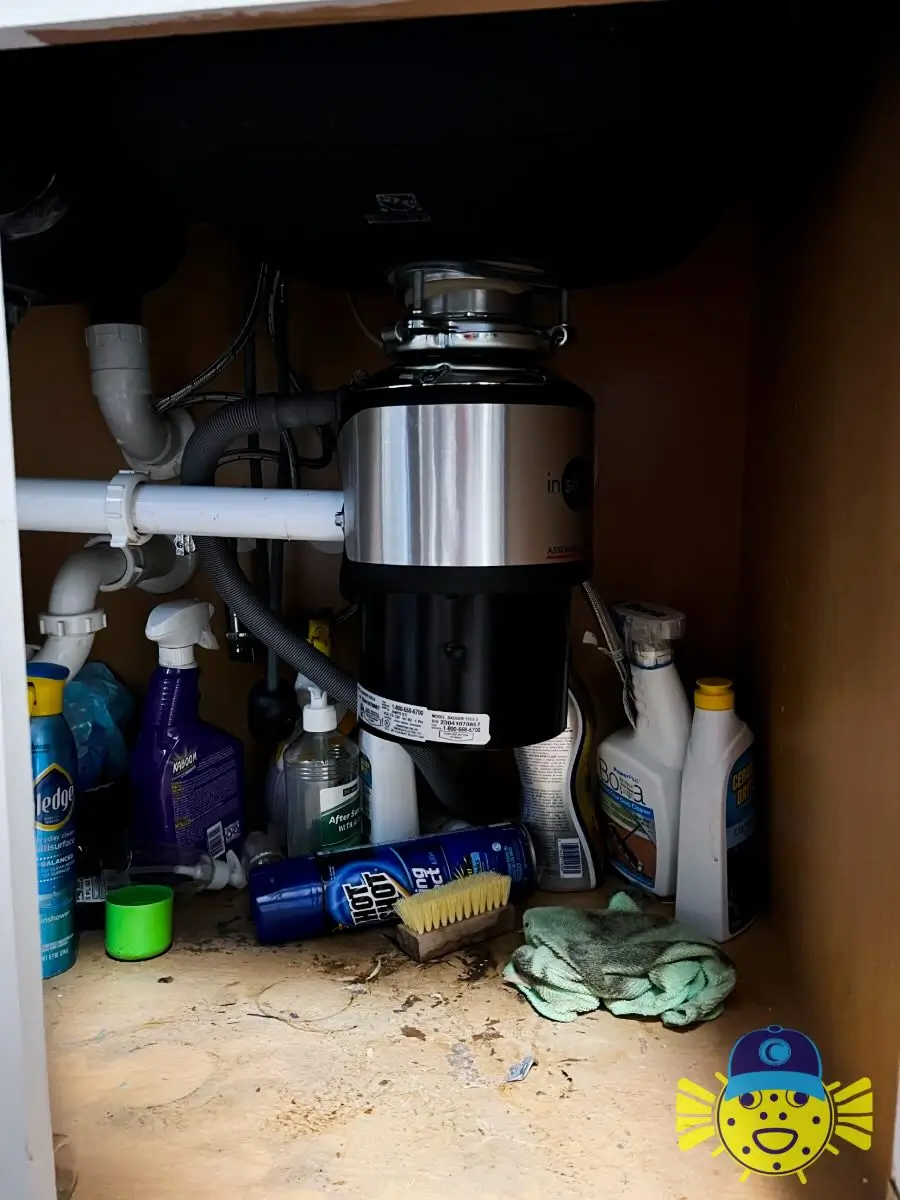 Newly installed InSinkErator garbage disposal under a kitchen sink by Swell Guy Plumbing in Goose Creek, SC.