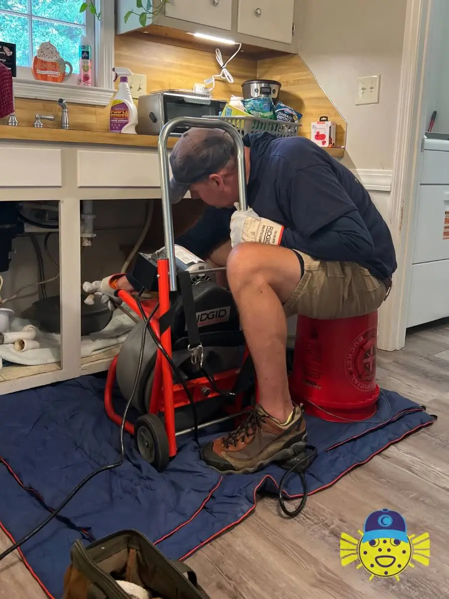 Plumber from Swell Guy Plumbing using a RIDGID drain snake machine to clear a clogged kitchen sink drain in Goose Creek, SC.