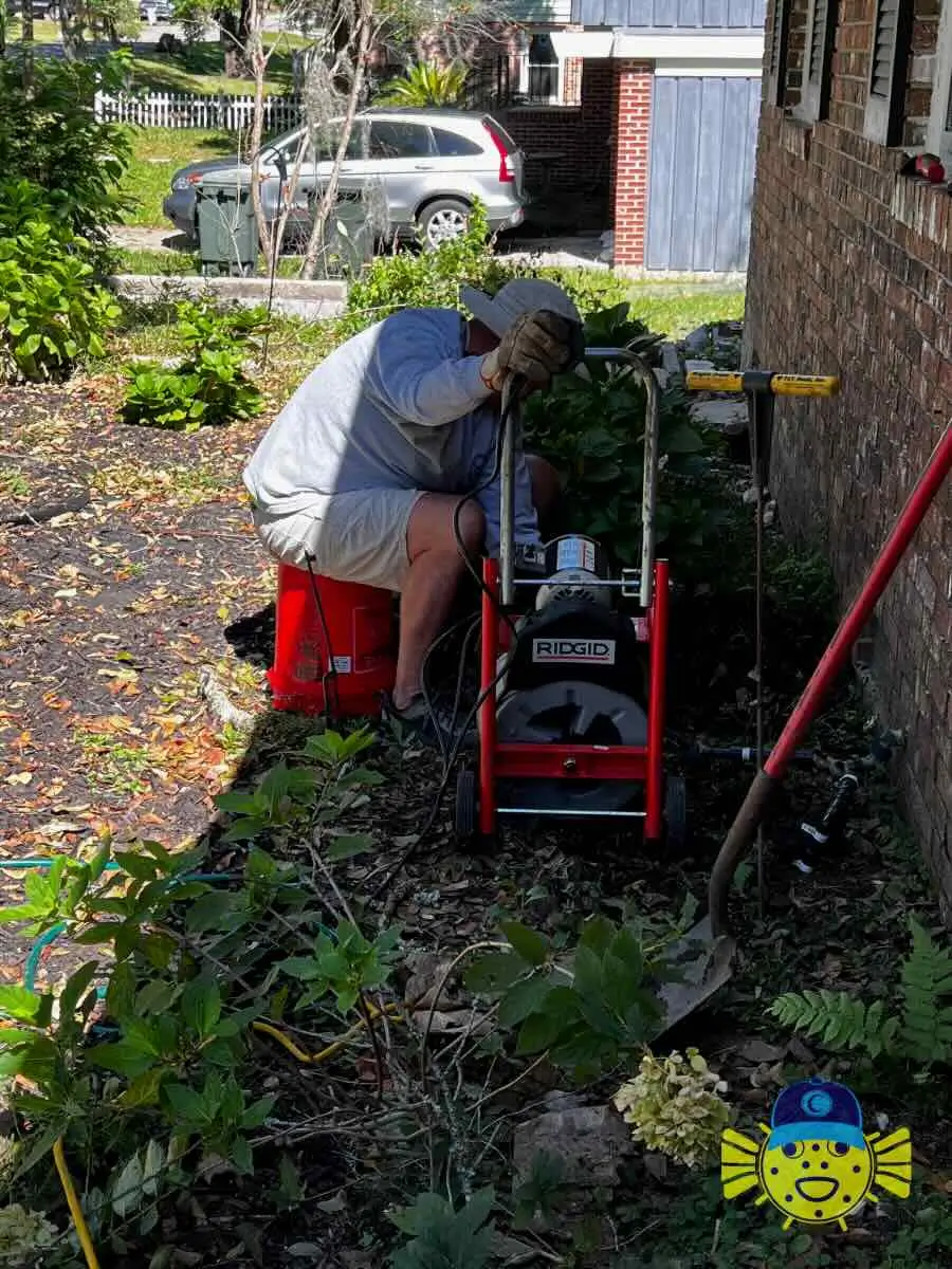 Swell Guy Plumbing technician operating a RIDGID drain snake machine outside a home in Hanahan, SC.