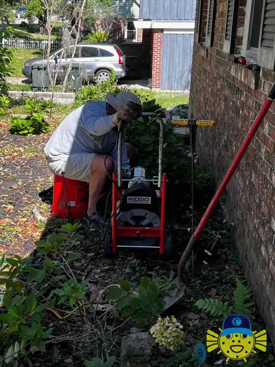 Plumber from Swell Guy Plumbing using a RIDGID drain cleaning machine outdoors in Goose Creek, SC.