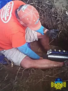 Steven Dyson, owner of Swell Guy Plumbing, working in a trench to complete an underground pipe repair.