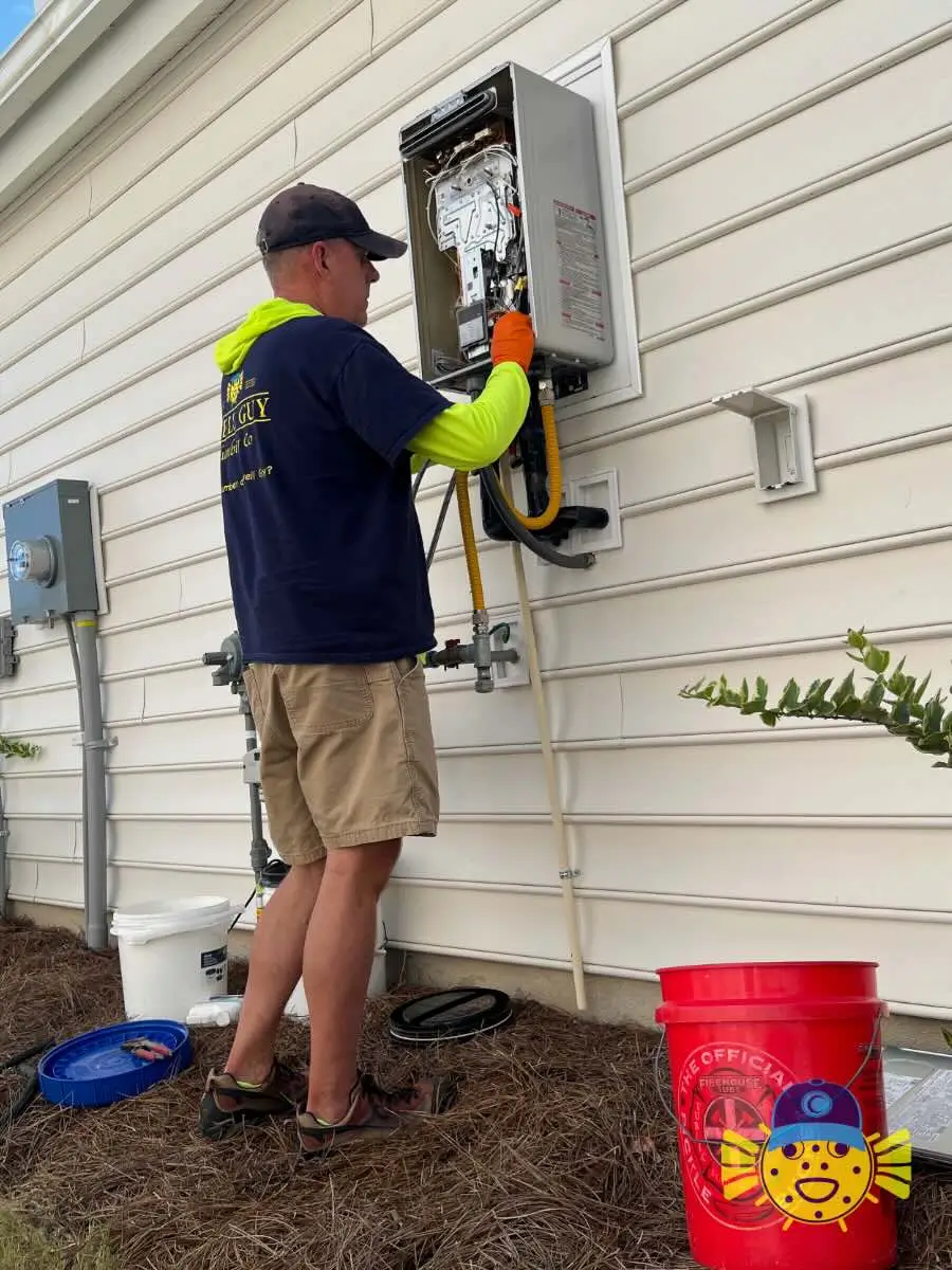 Plumber from Swell Guy Plumbing performing a tankless water heater flush on an outdoor unit in Summerville, SC.