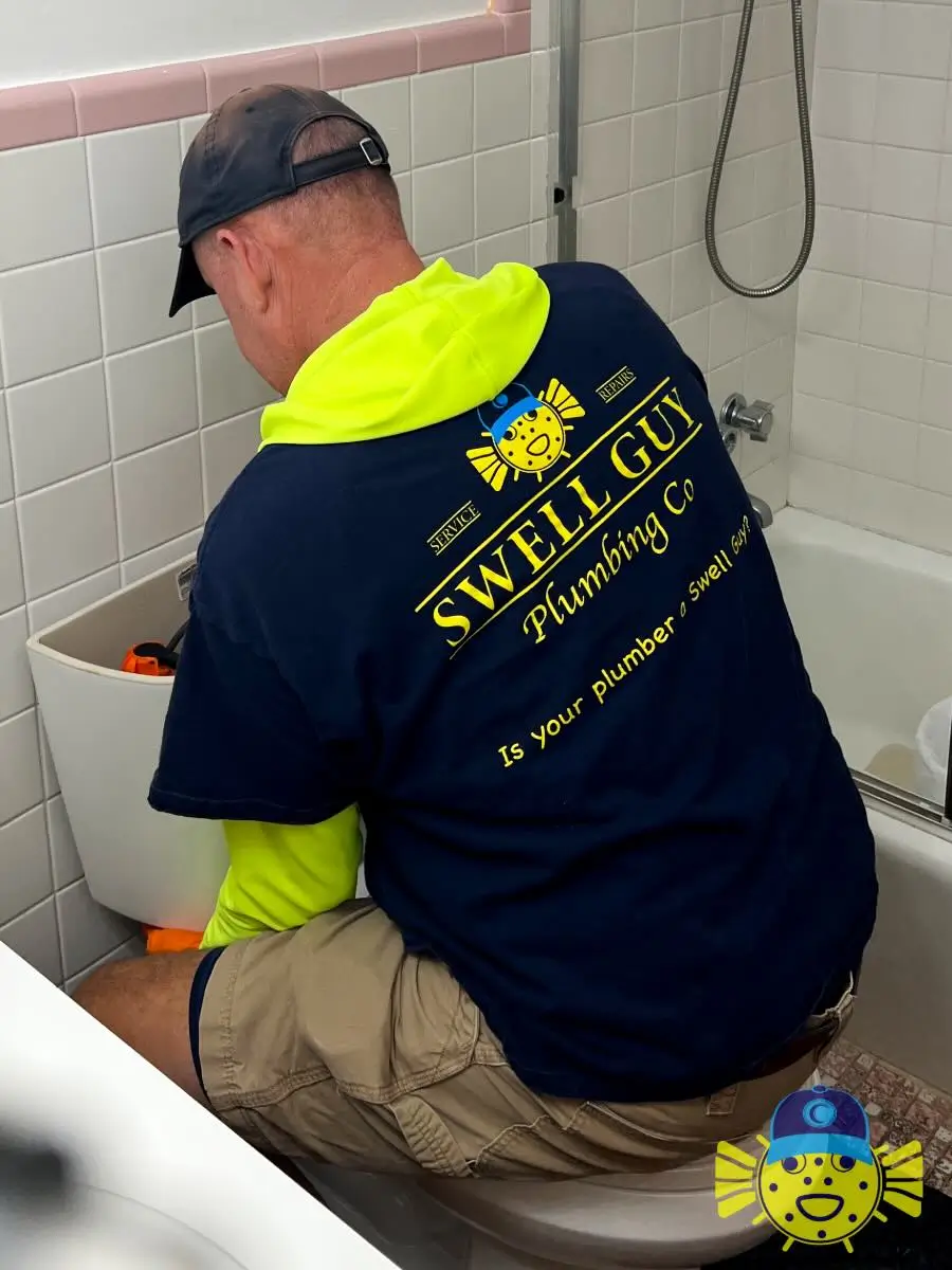 Swell Guy Plumbing technician performing a toilet tank repair in a Moncks Corner, SC bathroom.