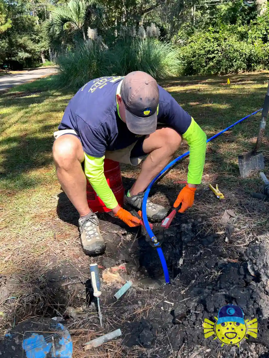 Swell Guy Plumbing technician installing a new blue main water service line connection in Summerville, SC.