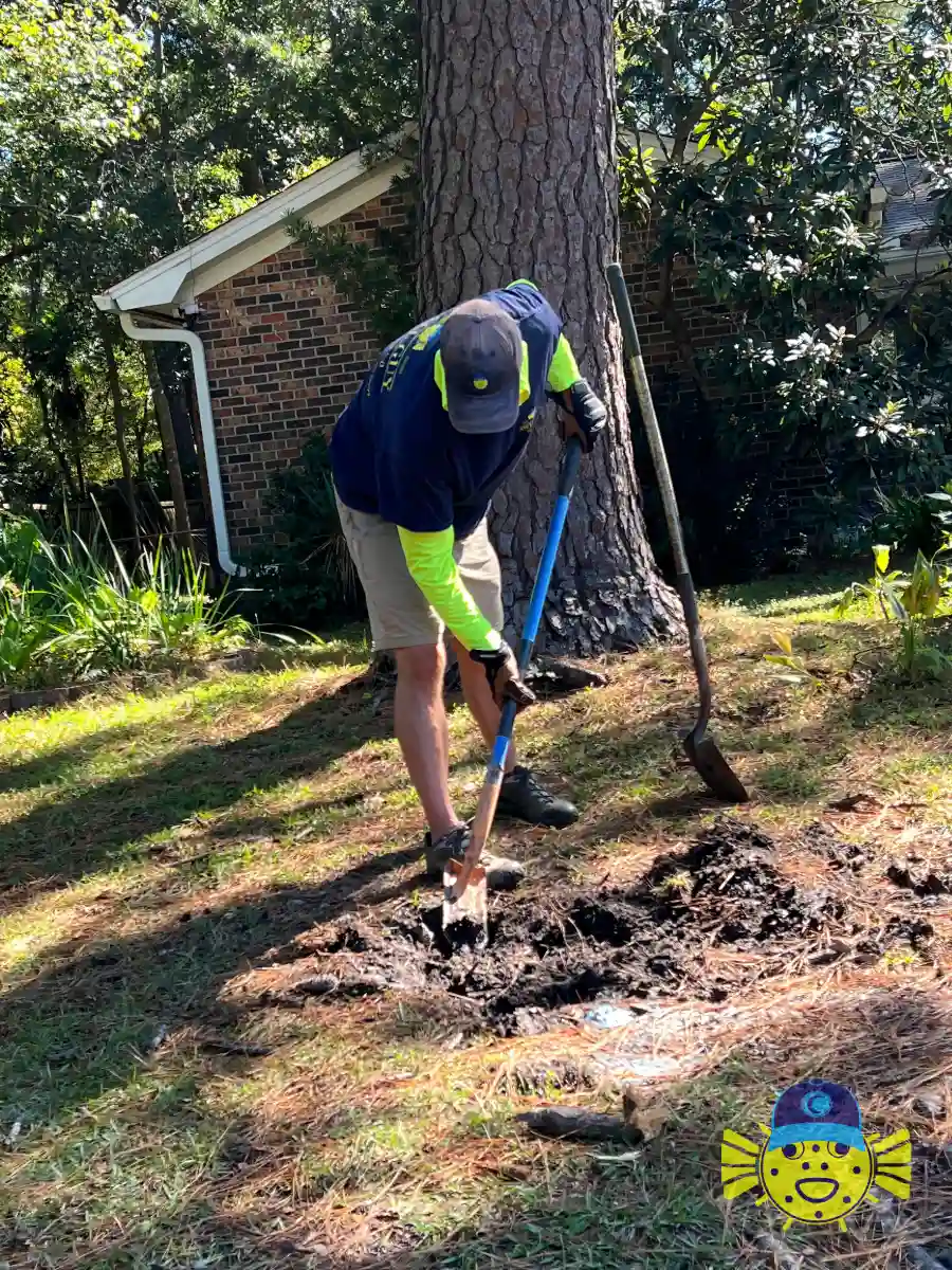 Swell Guy Plumbing technician digging a trench to access a damaged water line in Summerville, SC.