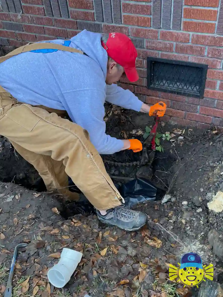 Swell Guy Plumbing technician repairing an underground pipe along a brick foundation during a sewer line repair in Ladson, SC.