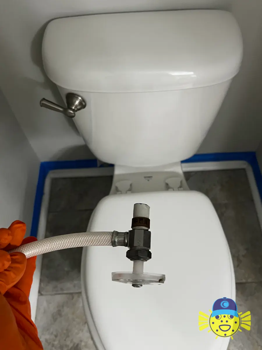 Swell Guy Plumbing technician holding a removed, worn shut-off valve during a toilet supply stop replacement in Hanahan, SC.